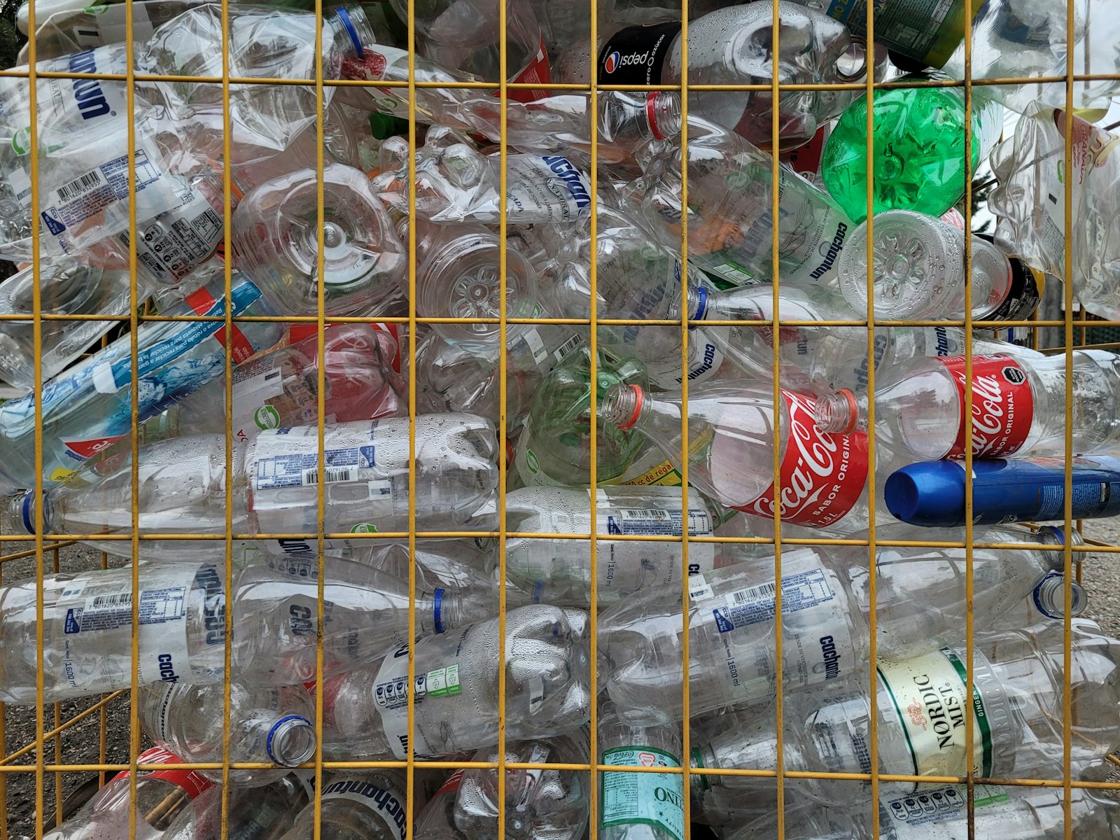 Plastic bottles collected in a recycling cage at the depot